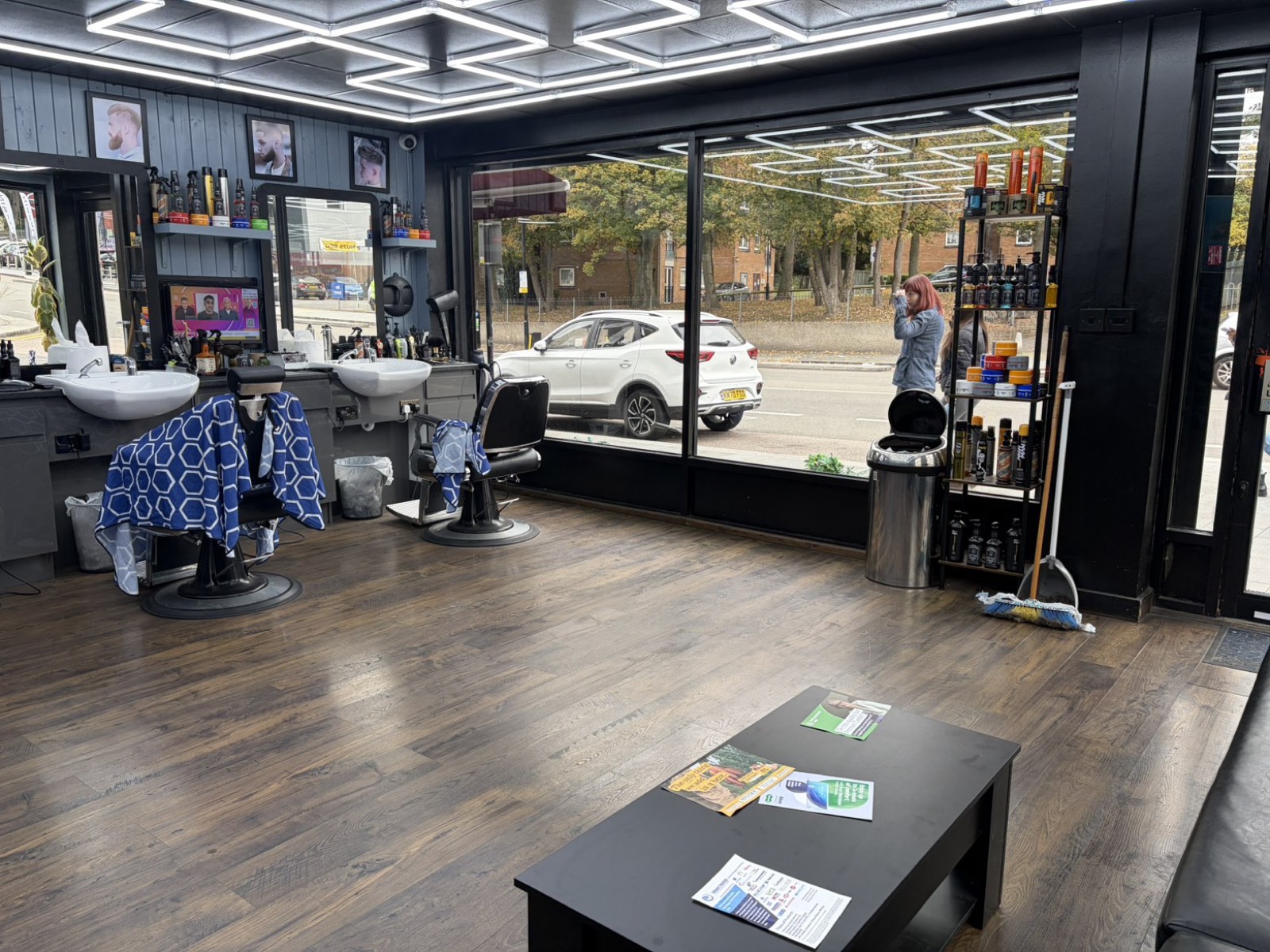 The length of the barbershop, mirrors down one side and daylight at the shopfront
