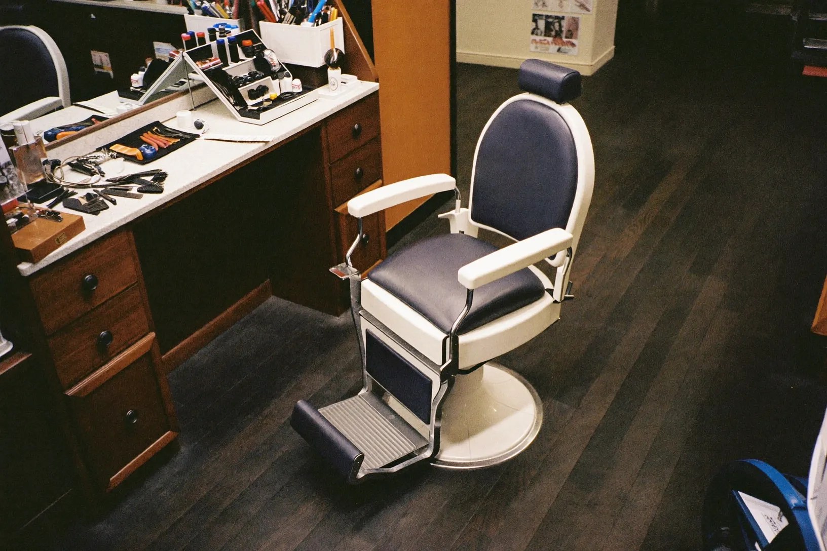 A barber's station, chair and counter ready for the next cut